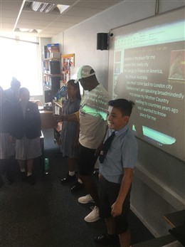 Photo:Paul Canoville told Y6 children at Servite school about his mother Udine's ambition to become a nurse in the new NHS.  She was part of the Windrush generation that the class celebrated through the calypso song 'London is the Place for Me' (by Lord Kitchener).